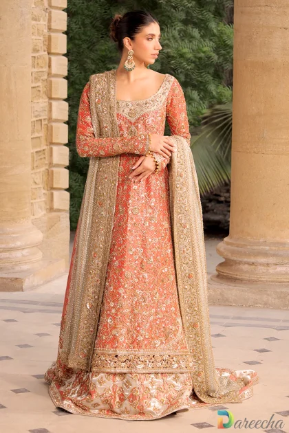 Front view of model in coral tissue A line long shirt lehenga displaying chatapati brocade skirt and embellished tissue shirt