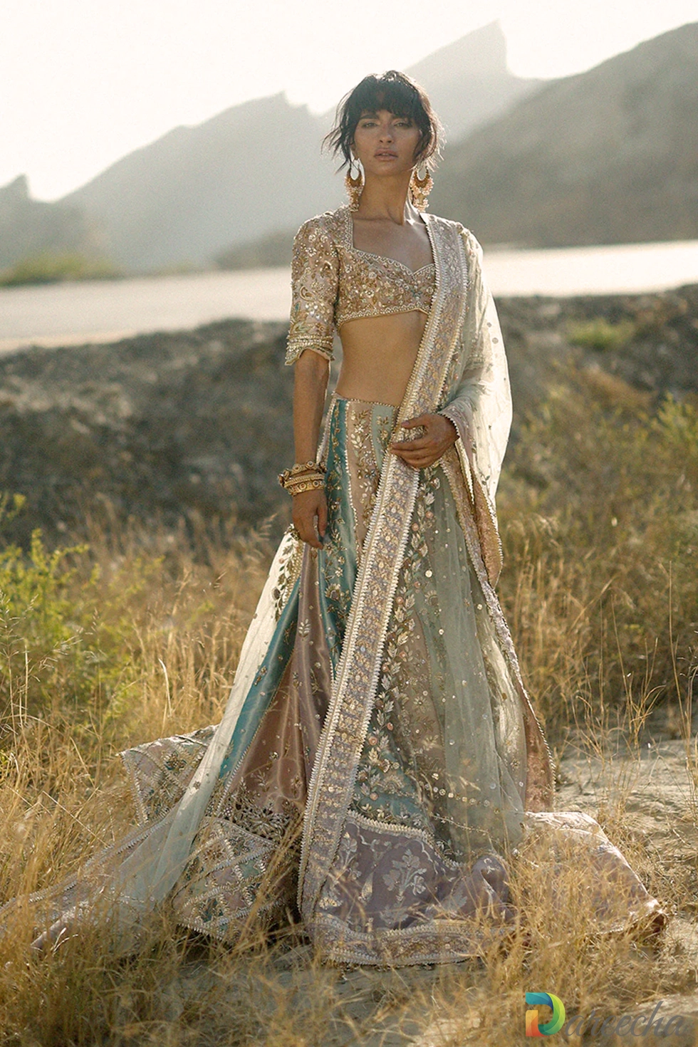 Full length outdoor portrait of pastel bridal lehenga with layered tissue skirt and hand woven lilac pallu