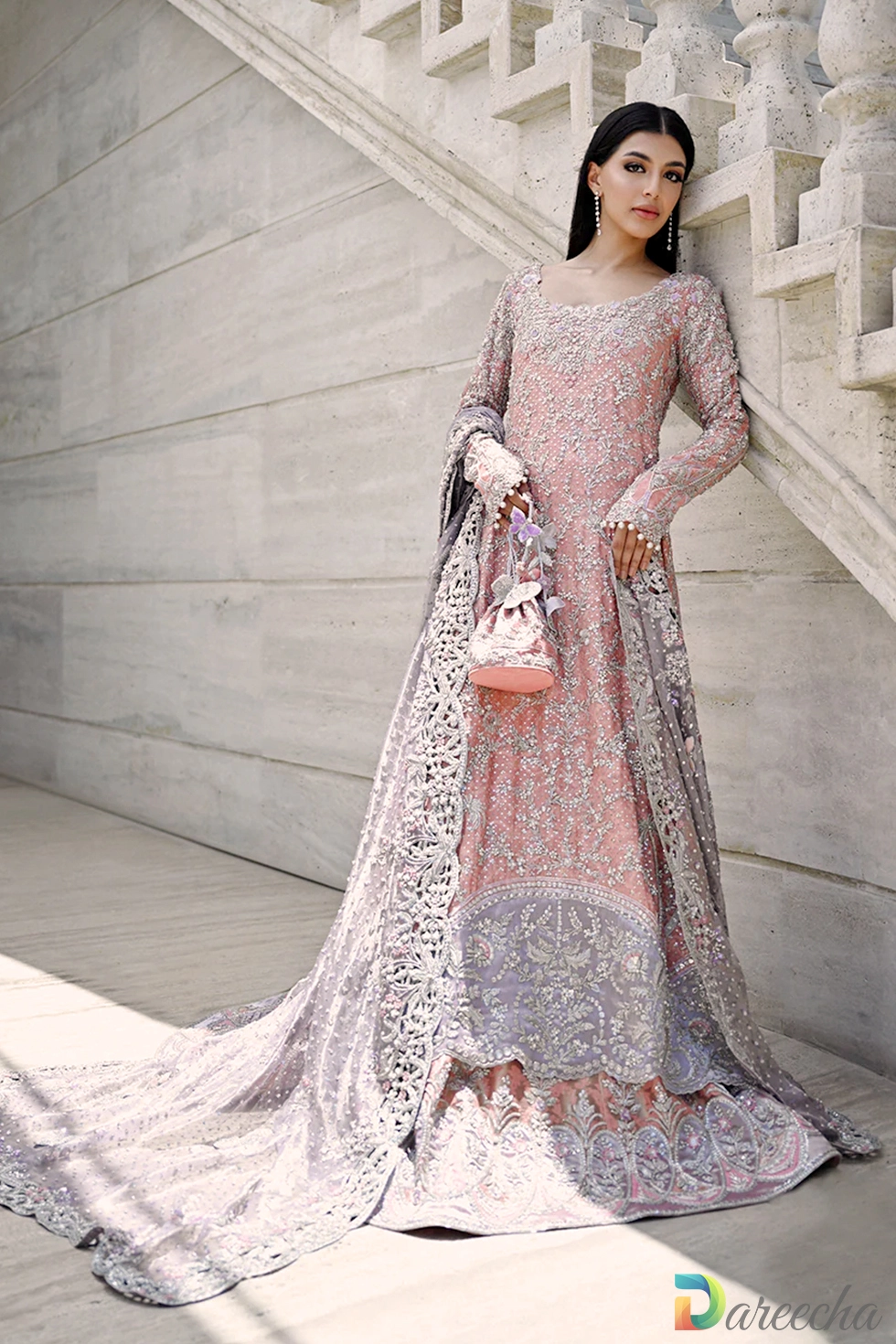 Front view of rose quartz peshwas lehenga with matching embroidered cotton net pouch and scalloped sleeves