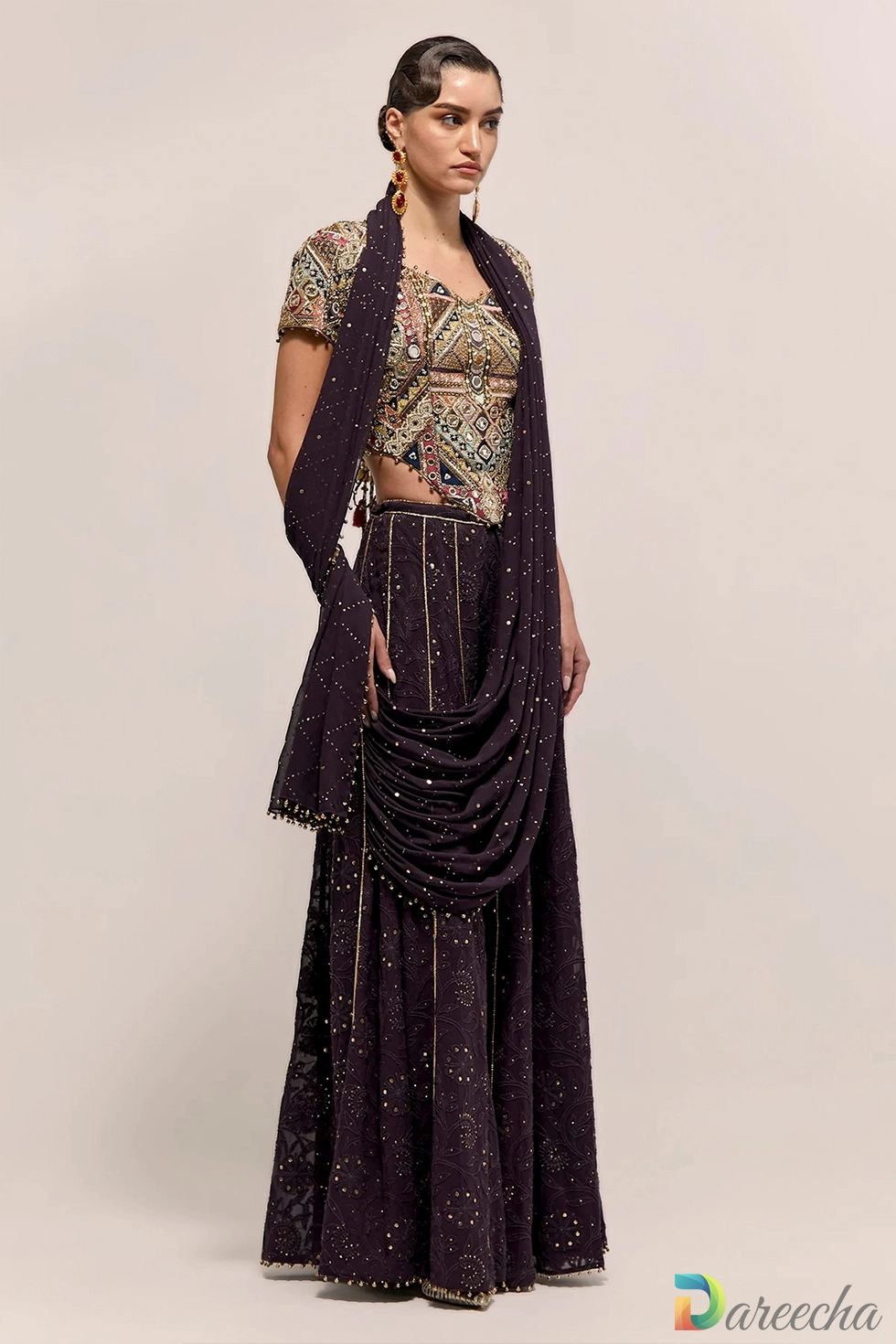 Three quarter angle view of model in dark purple georgette sharara displaying beaded fringe hem