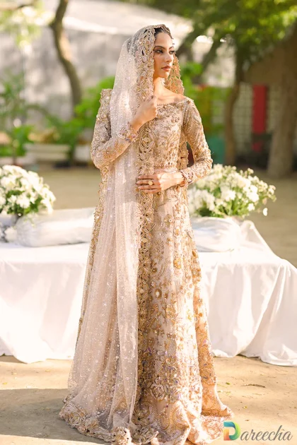 Front view close up highlighting off shoulder neckline and zardoze sequin flowers on pale pink tulle peshwas lehenga