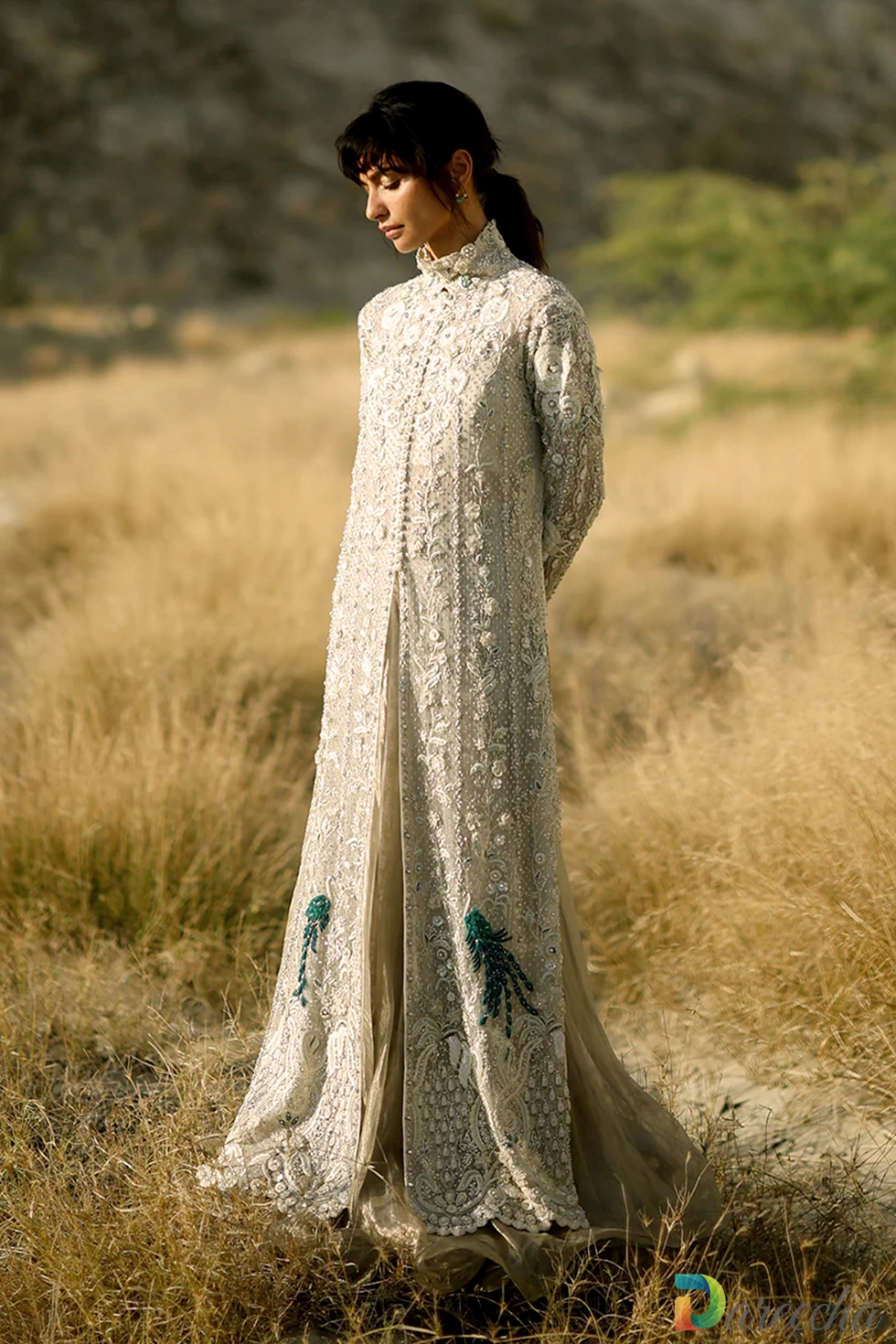 Front view portrait of champagne tulle peshwas with hand worked zardoze vines and ruffled tissue lehenga hem