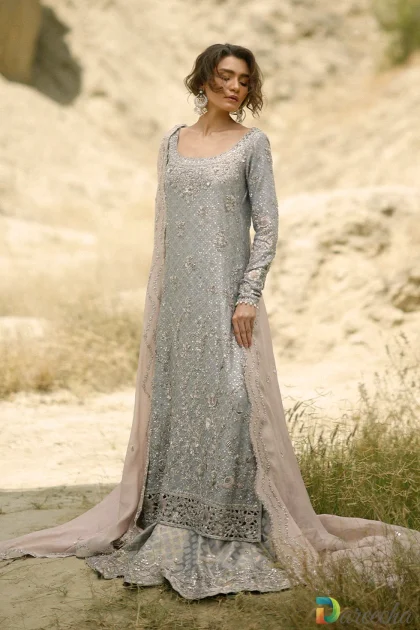 Full length standing portrait of steel blue long shirt with lehenga and blush embroidered cotton net dupatta