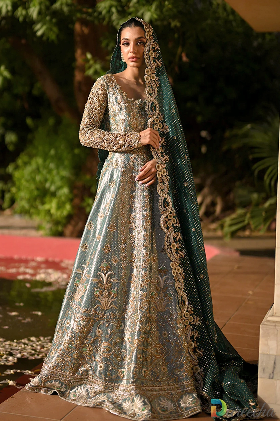 Full length portrait of mint green tissue peshwas with emerald green organza dupatta draped over head