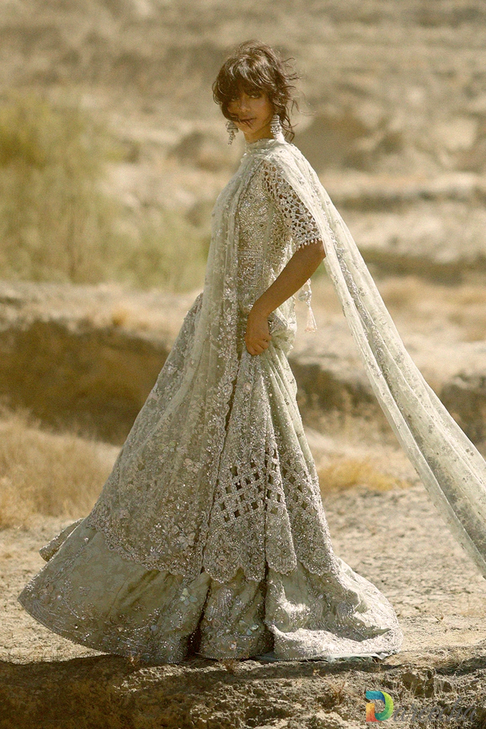 Side angle view showing scalloped cutwork hem and tissue lehenga flare on tissue peshwas lehenga