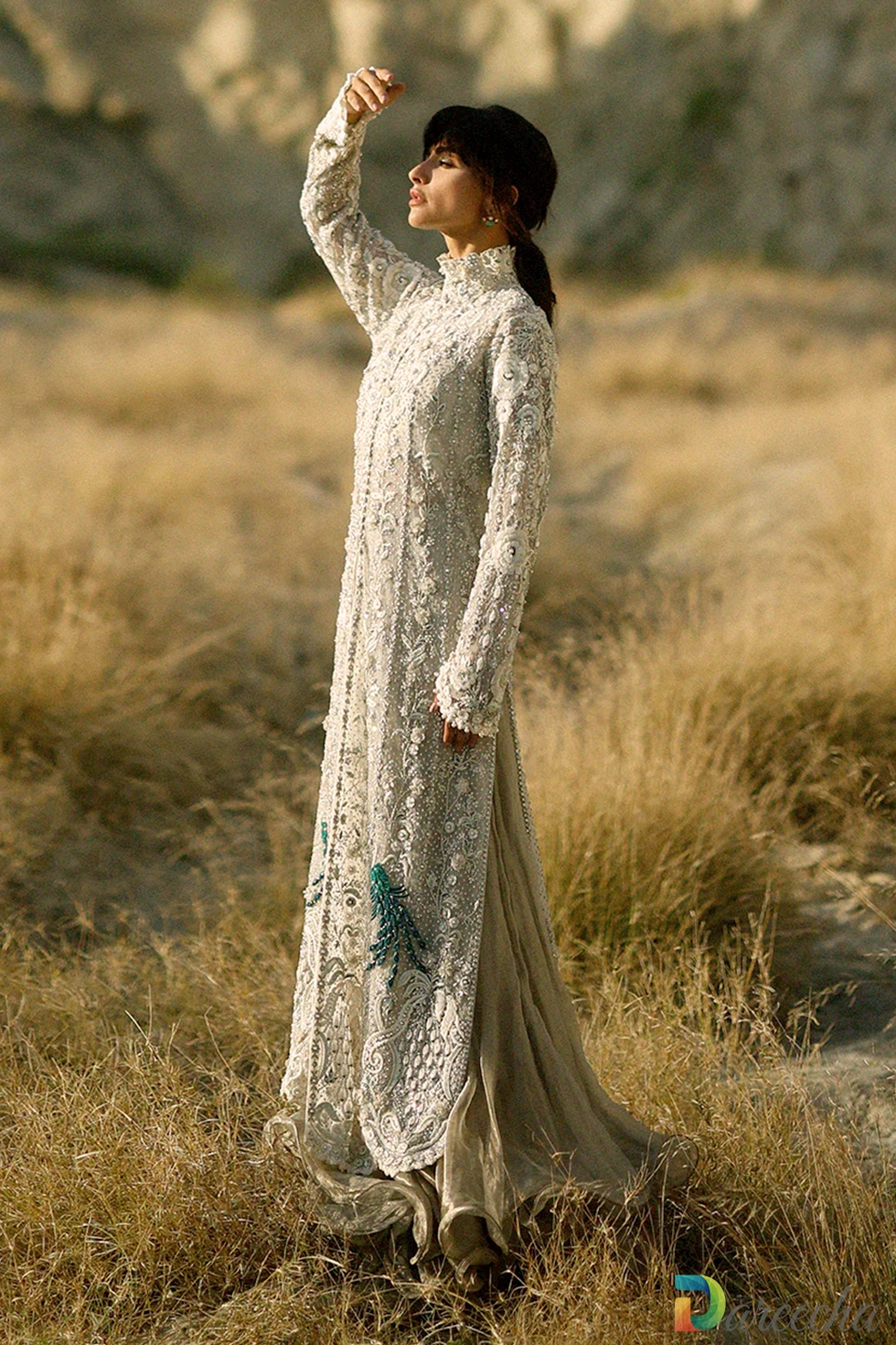Side angle portrait of champagne tulle peshwas with band collar and three dimensional floral embroidery