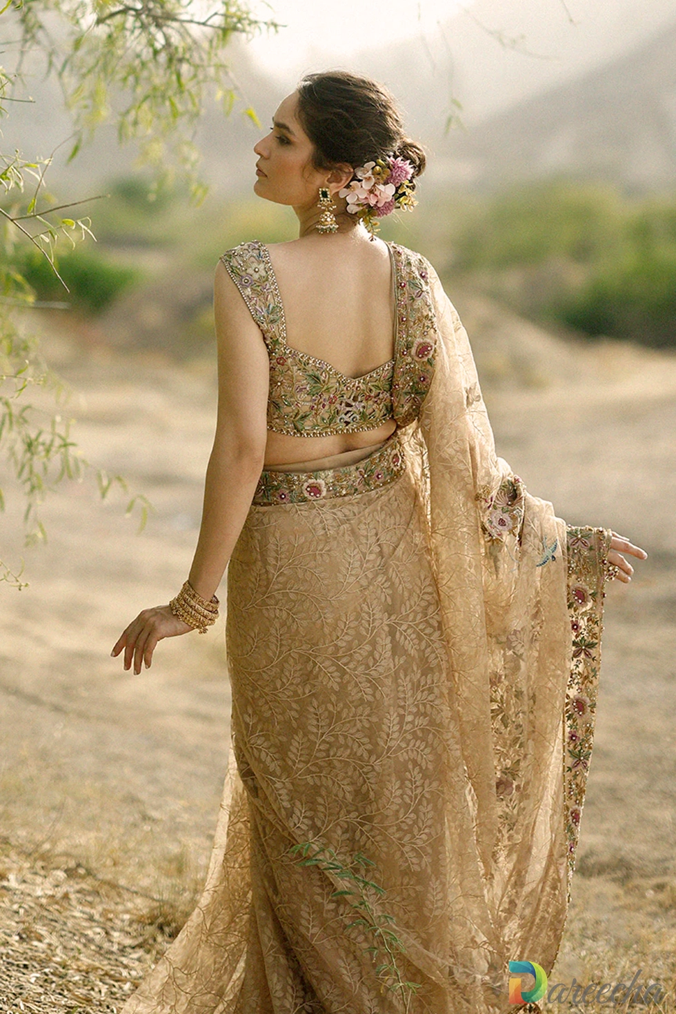 Medium shot of model wearing dusty gold tulle saree with hands gracefully folded showing embroidered pallu detail[cite: 26]