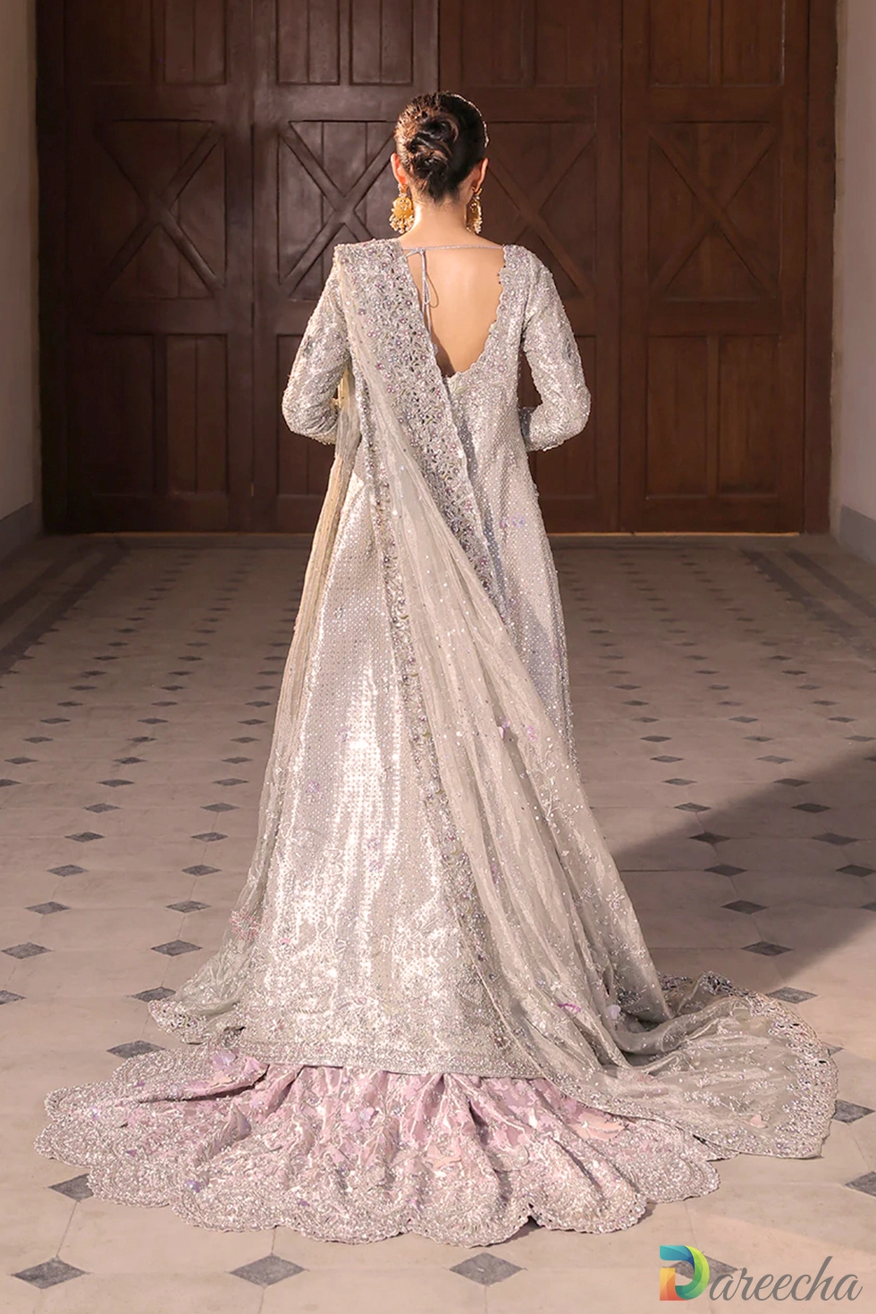 Back view of platinum tissue bridal peshwas showing deep scoop back and sweeping brocade lehenga train