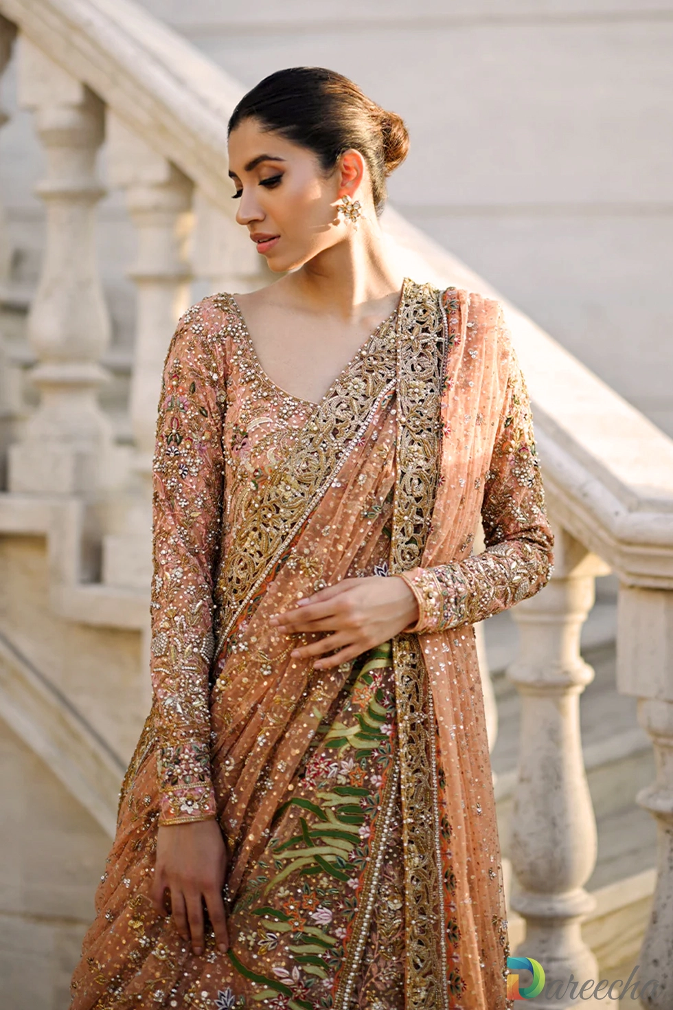 Close up view of upper bodice showcasing zardozi embroidery and sequin work on coral tulle with draped dupatta border[cite: 21]