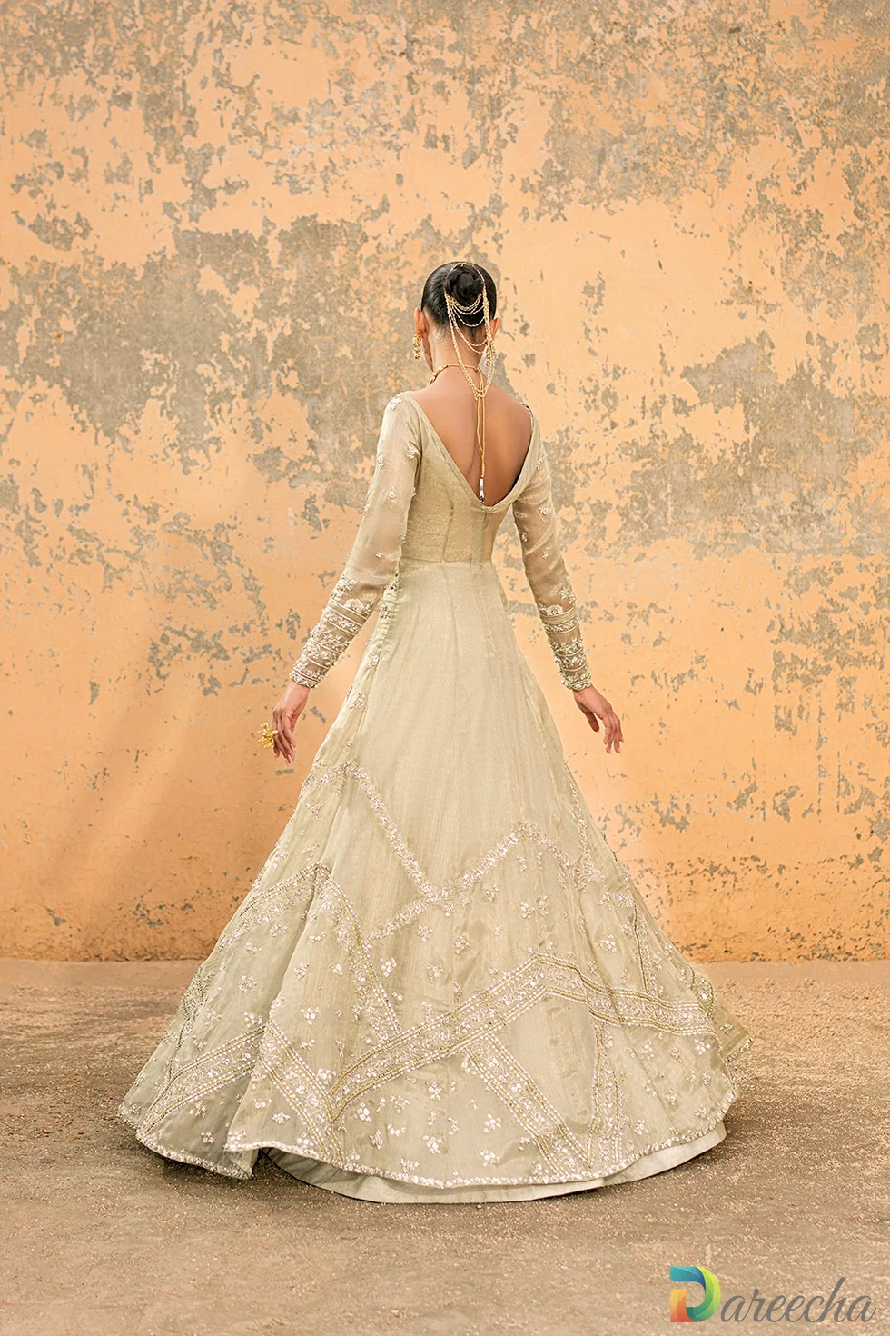 Back view highlighting deep V neck cut and flared tissue shimmer skirt of olive green front open gown with lehenga