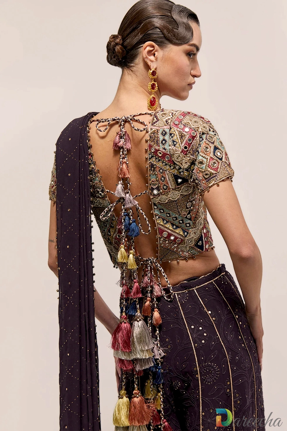 Back view displaying tie back open back choli with multi color tassels on dark purple georgette sharara