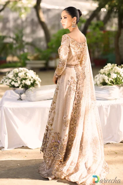 Back view showing structured waist fit and trailing hem of pale pink tulle peshwas lehenga