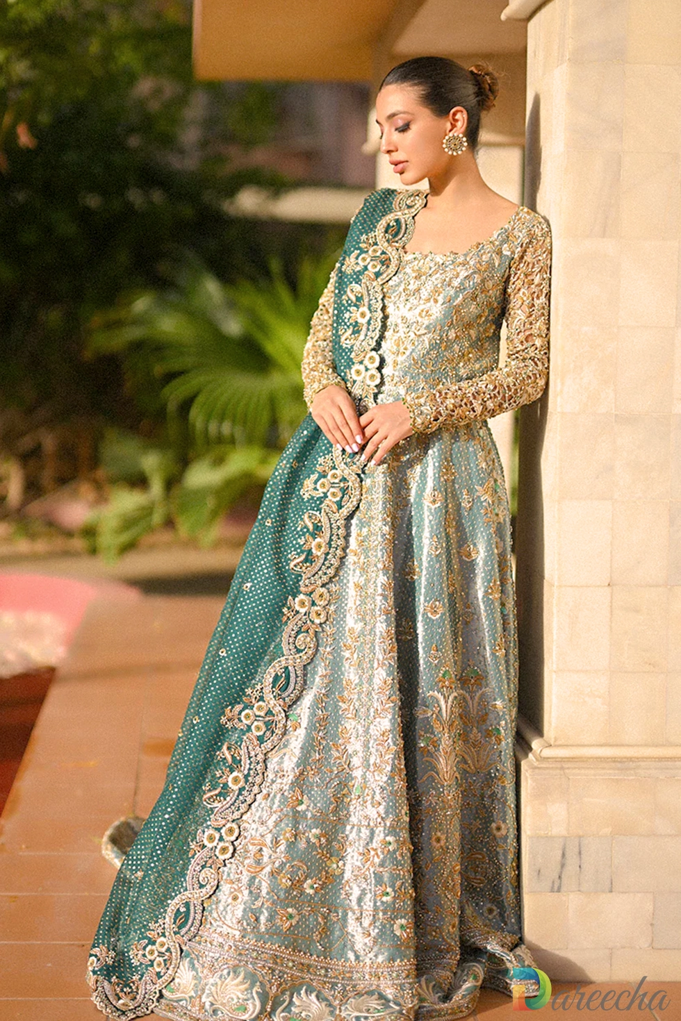 Close up pose highlighting round neckline embroidery and cutwork sleeves on mint green tissue peshwas