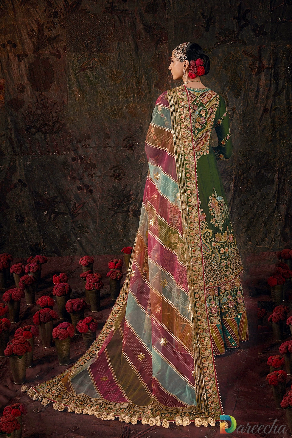 Back view of forest green kurti showing peacock floral embroidery motif and draped multi hued tulle dupatta with tassels