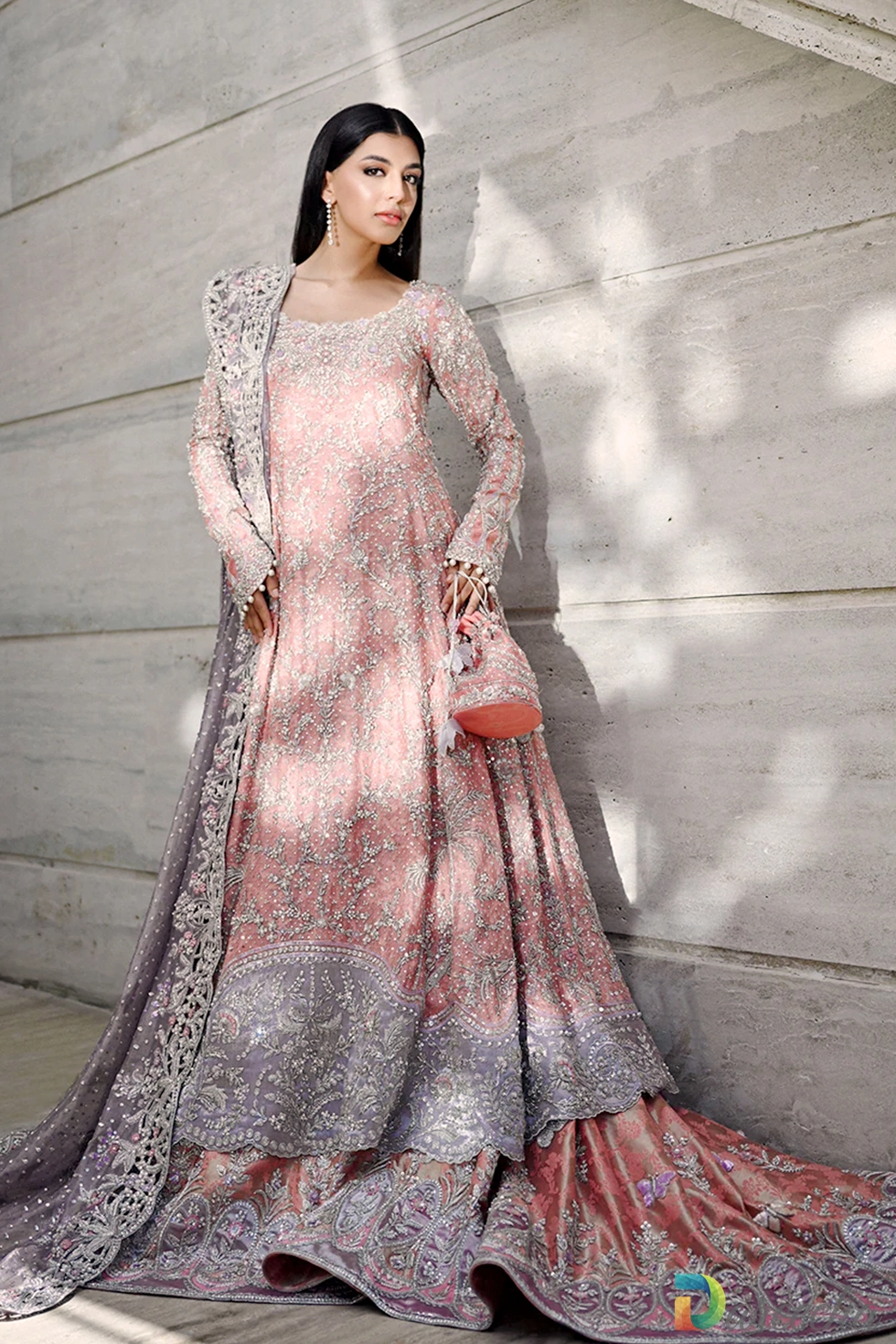 Full length pose on marble stairs showing rose quartz peshwas lehenga with draped lilac tissue dupatta