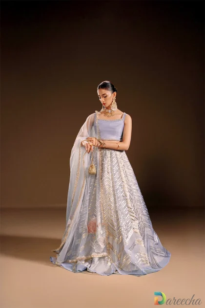 Full length view of model wearing periwinkle organza lehenga choli with geometric foil print and sheer net dupatta