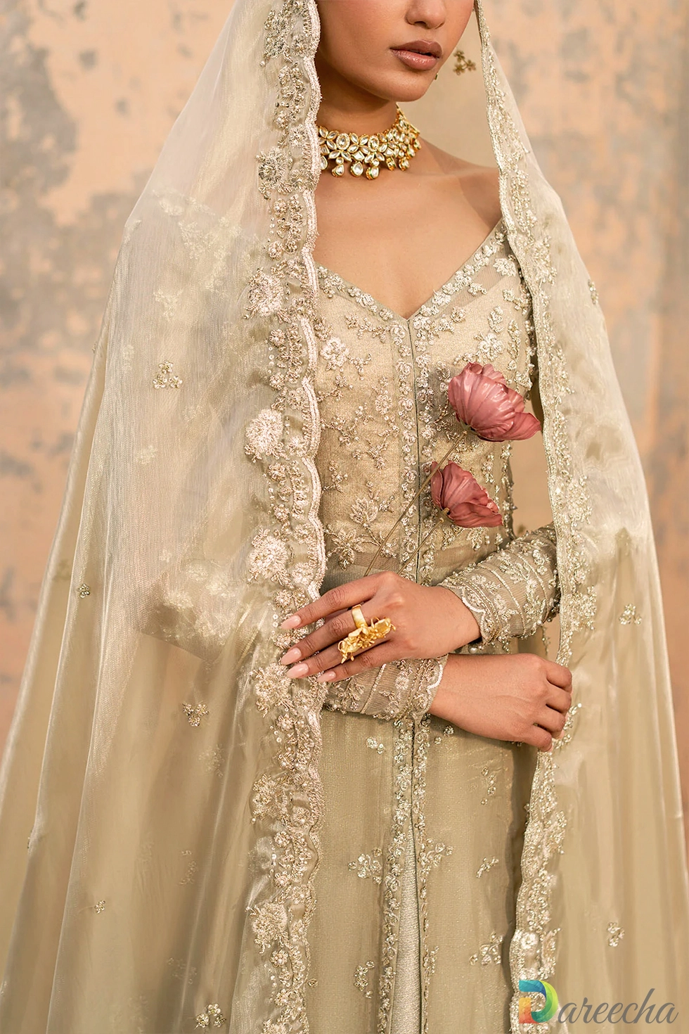 Close up detail of hand embroidered bodice and scalloped dupatta border on olive green front open gown with lehenga