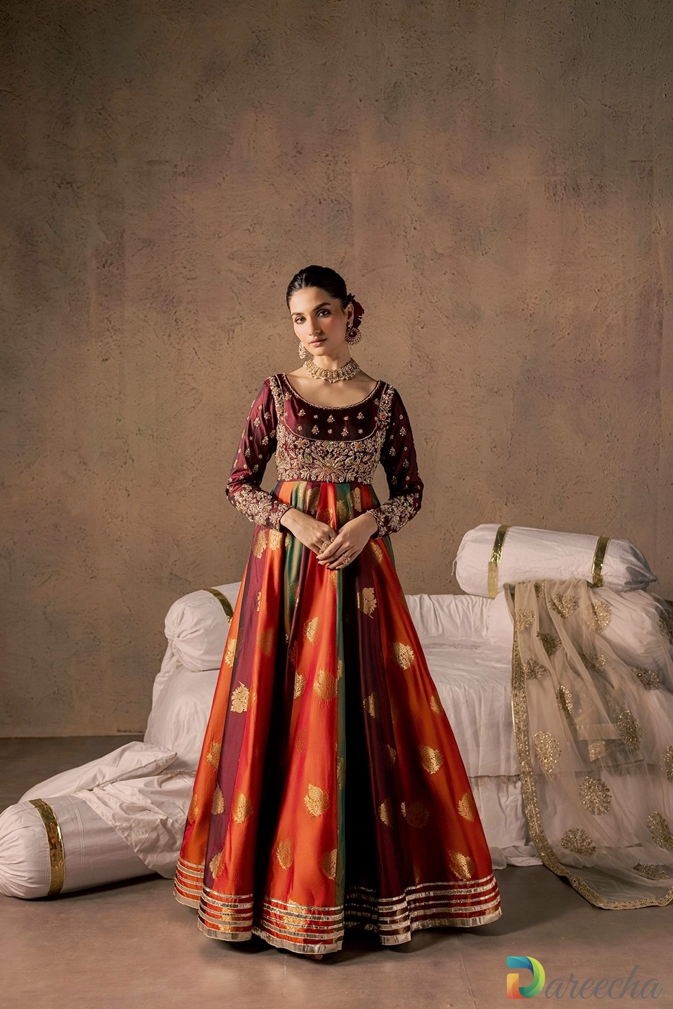 Full front pose displaying gold brocade panel flare