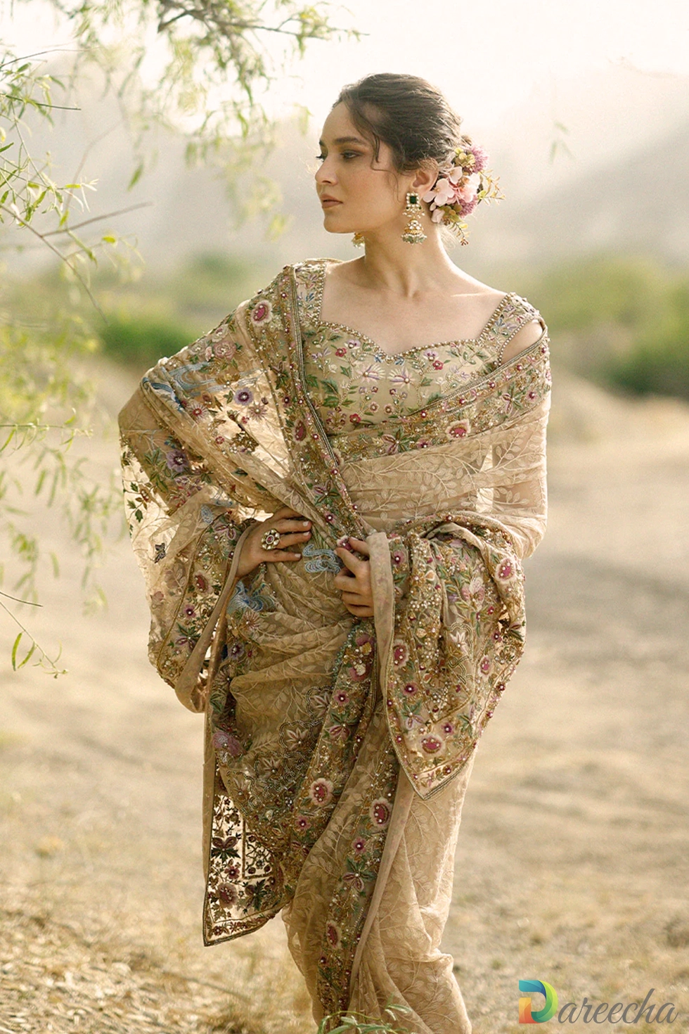 Medium shot of model wearing dusty gold tulle saree with hands gracefully folded showing embroidered pallu detail[cite: 26]