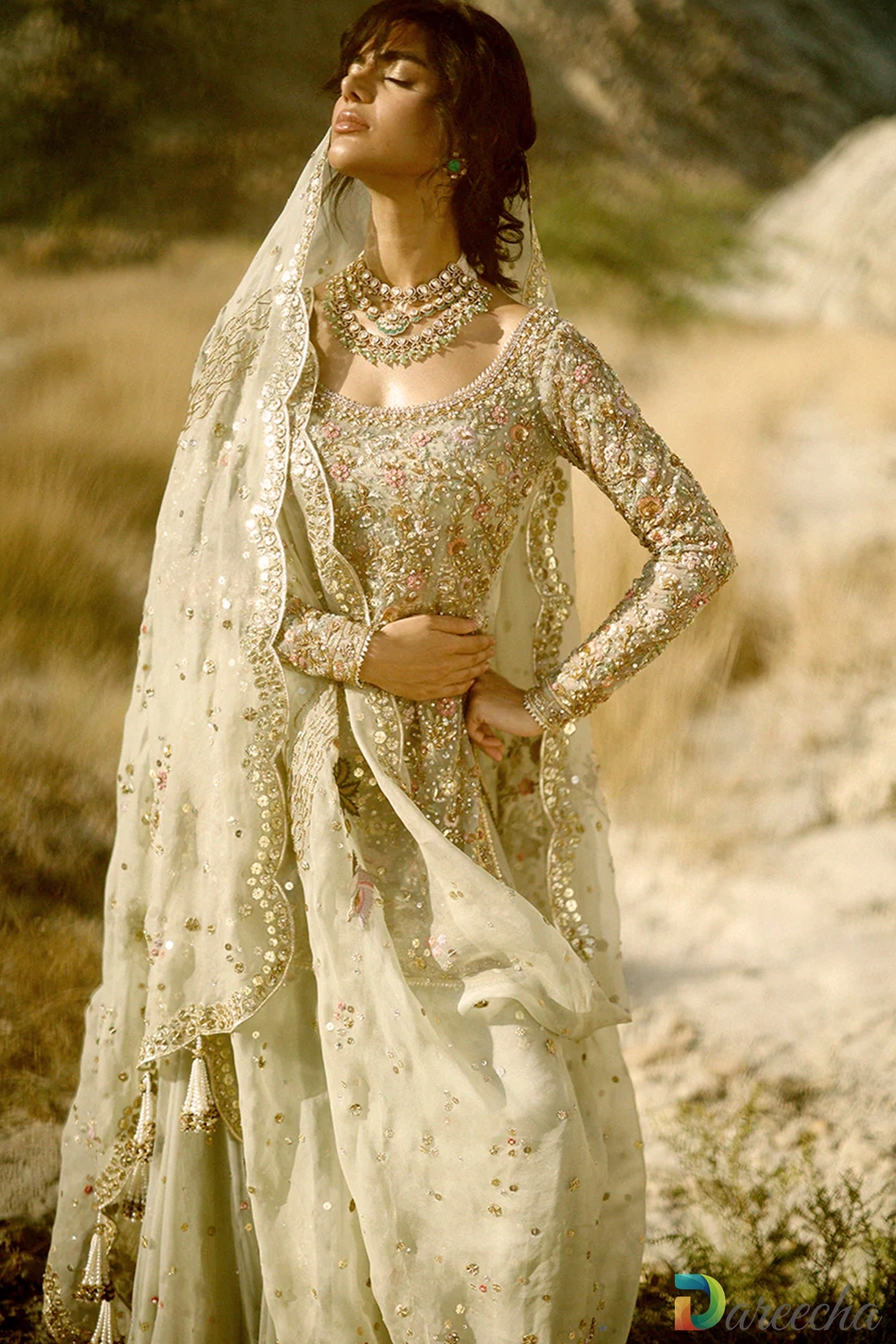 Detailed close up of round neckline and hand embellished sleeves on celadon tulle short shirt lehenga
