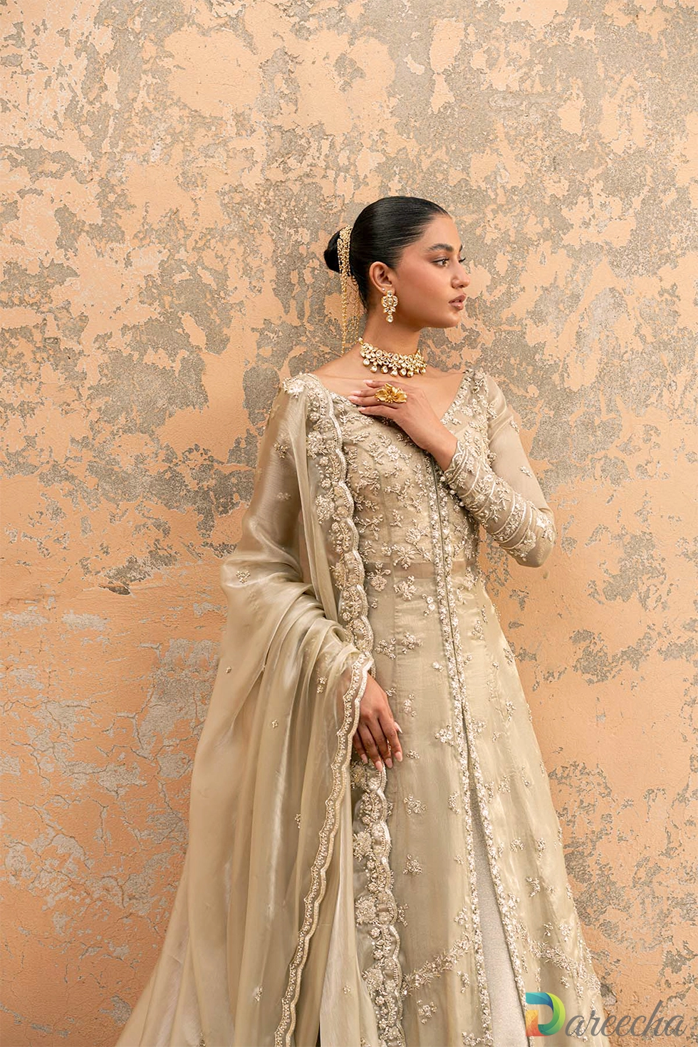 Three quarter length portrait showcasing geometric floral embroidery on masuri front open gown with lehenga