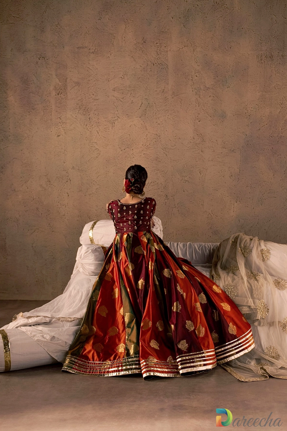 Model seated showing expansive multi color silk flare
