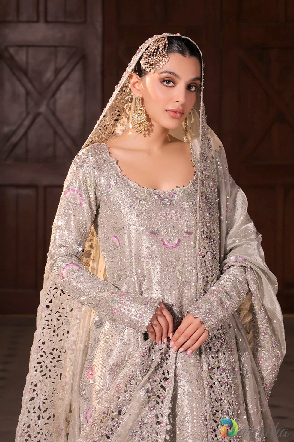 Bridal portrait showing hand cutwork tissue dupatta draped over head with pearl and sequin details