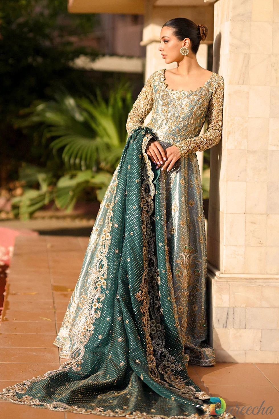 Front standing view of mint green tissue peshwas with heavy gold zardoze bodice and flared tissue lehenga