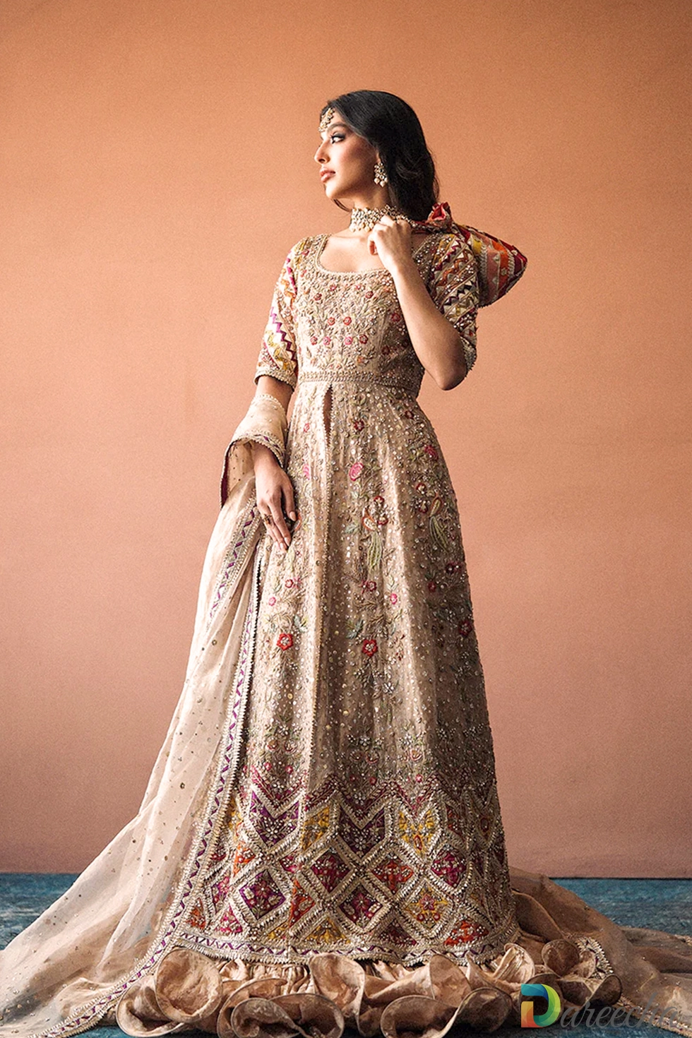 Full flared silhouette of copper tissue peshwas with multi colored applique hem and ruffled skirt border