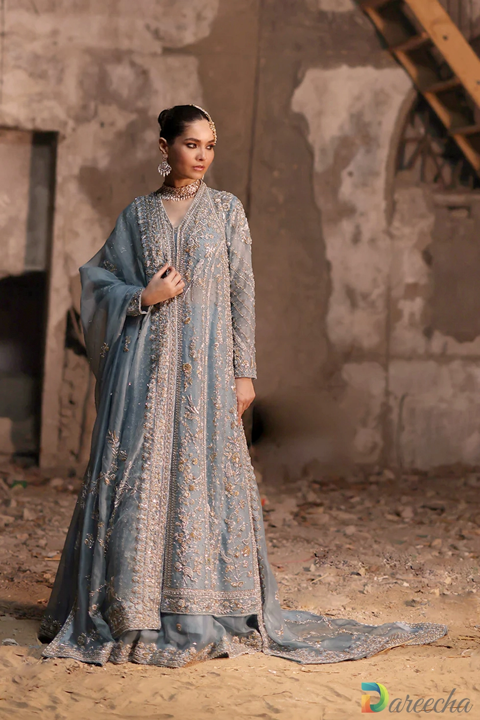 Three quarter standing portrait of powder blue front open lehenga jacket with draped organza dupatta over head