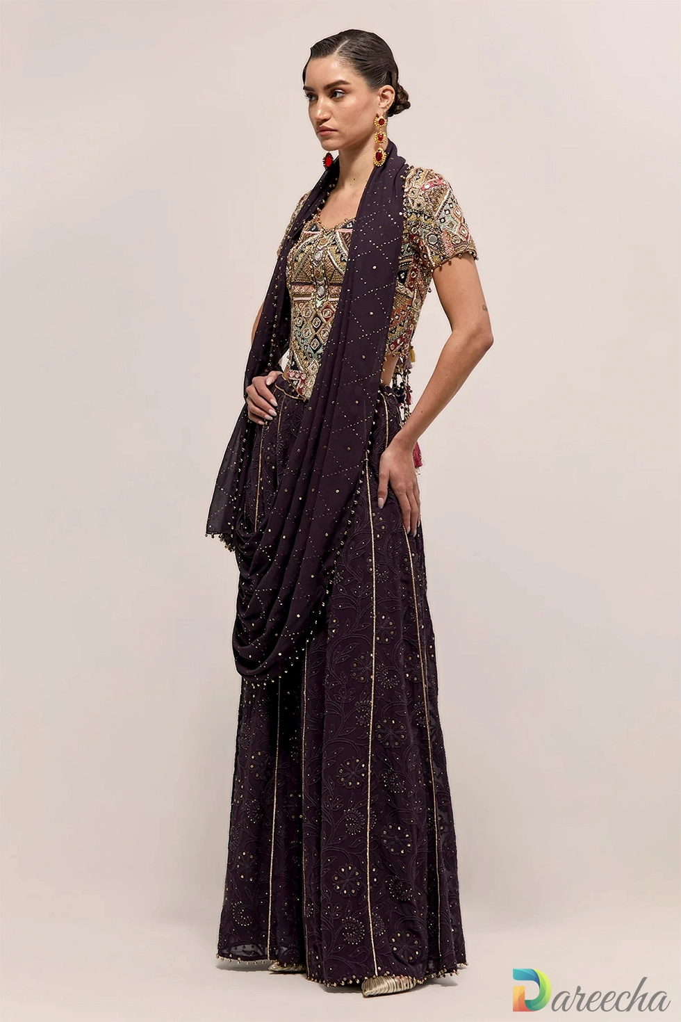 Front side view of dark purple georgette sharara with multi color embroidered choli and attached mukaish pallu