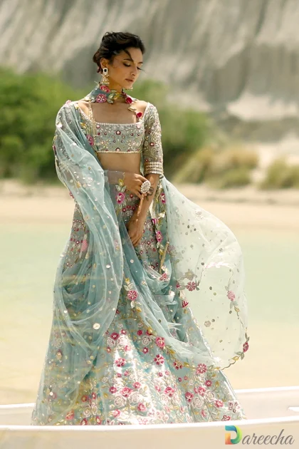 Front profile of ice blue tissue lehenga displaying square neckline choli and metallic tissue sheen