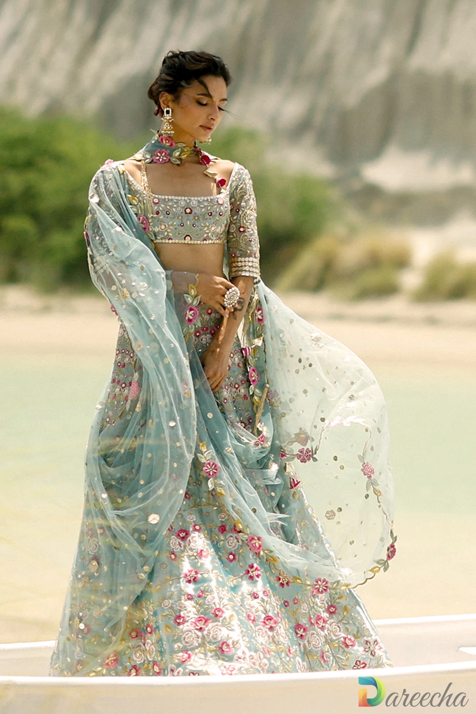 Front profile of ice blue tissue lehenga displaying square neckline choli and metallic tissue sheen