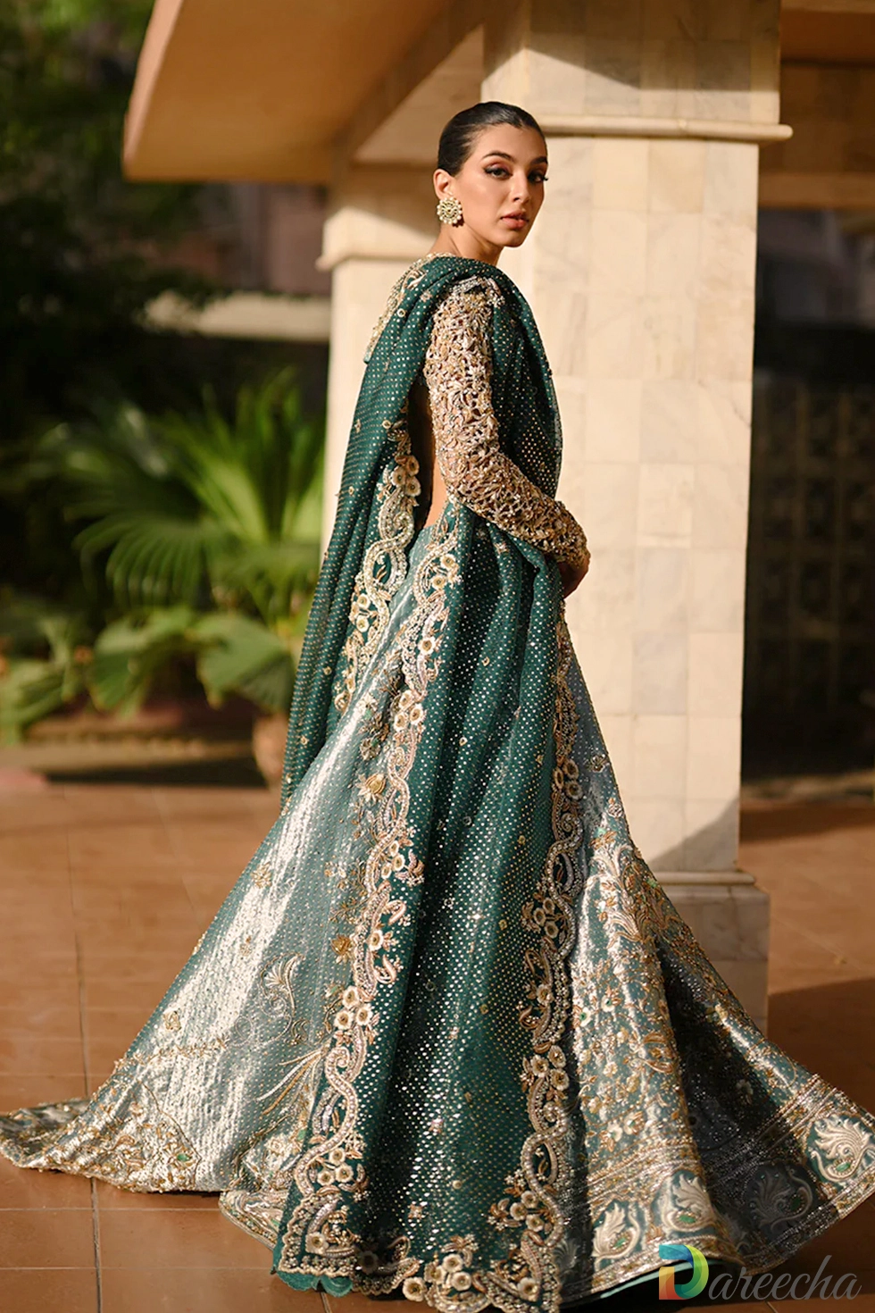 Side view of mint green tissue peshwas featuring back cutouts and gold silver zardoze embroidery