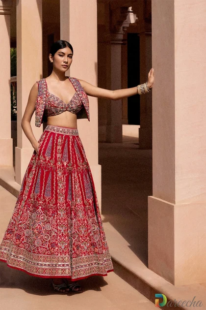 Full length front view of model posing in vintage red matka silk lehenga set with pockets and mirror embellishment