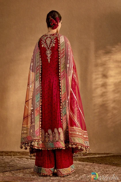Back view of a deep maroon printed silk kurta set showcasing hand-embroidered back motifs and draped organza dupatta.