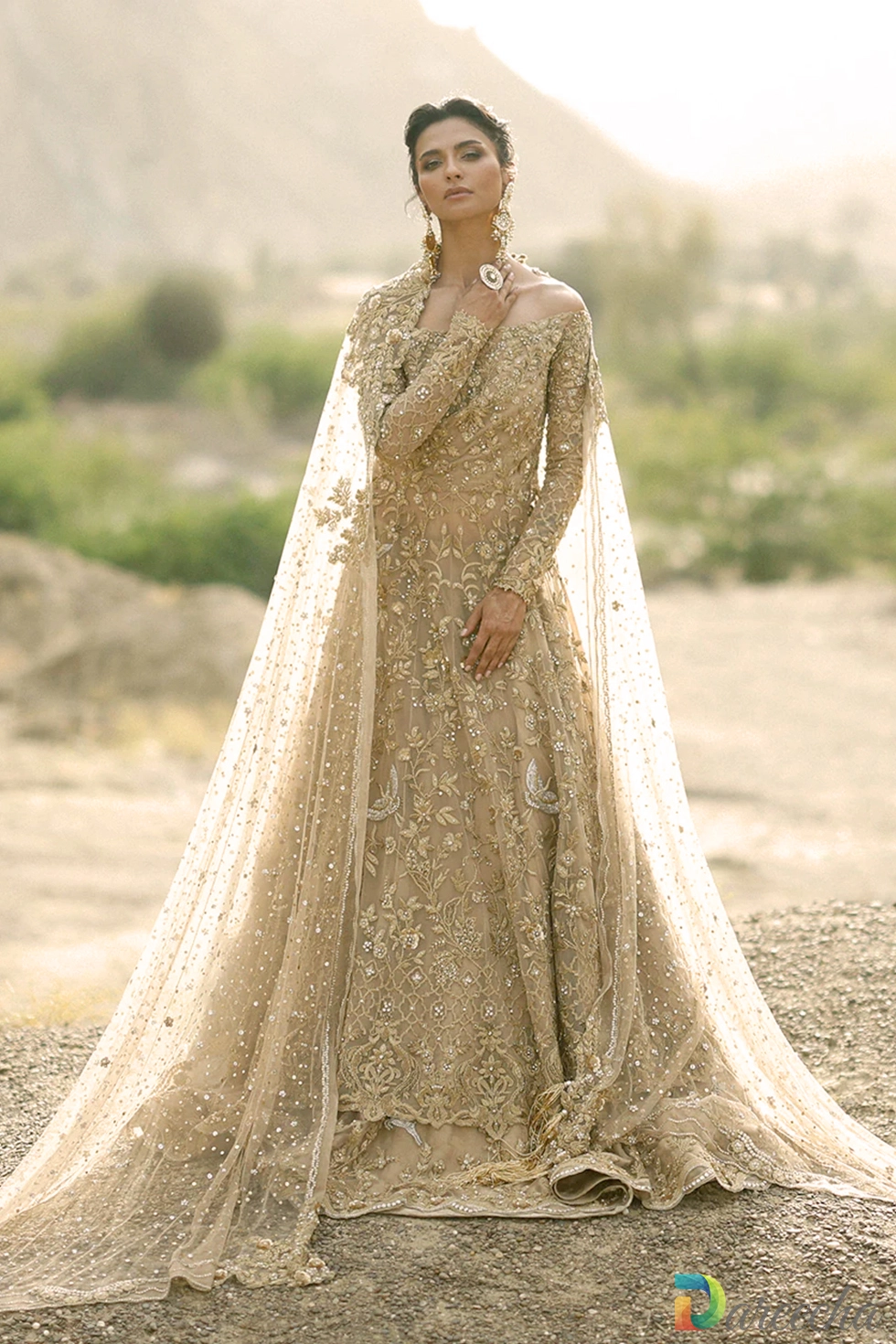 Full-length view of slim fit gold bridal peshwas with scalloped hem and dual dupattas.