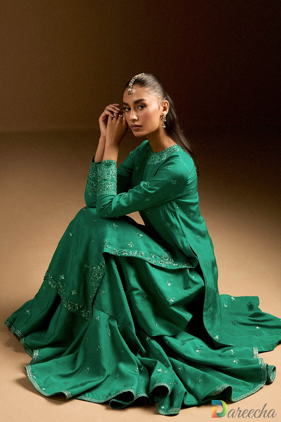 Seated pose showcasing flared gharara hem