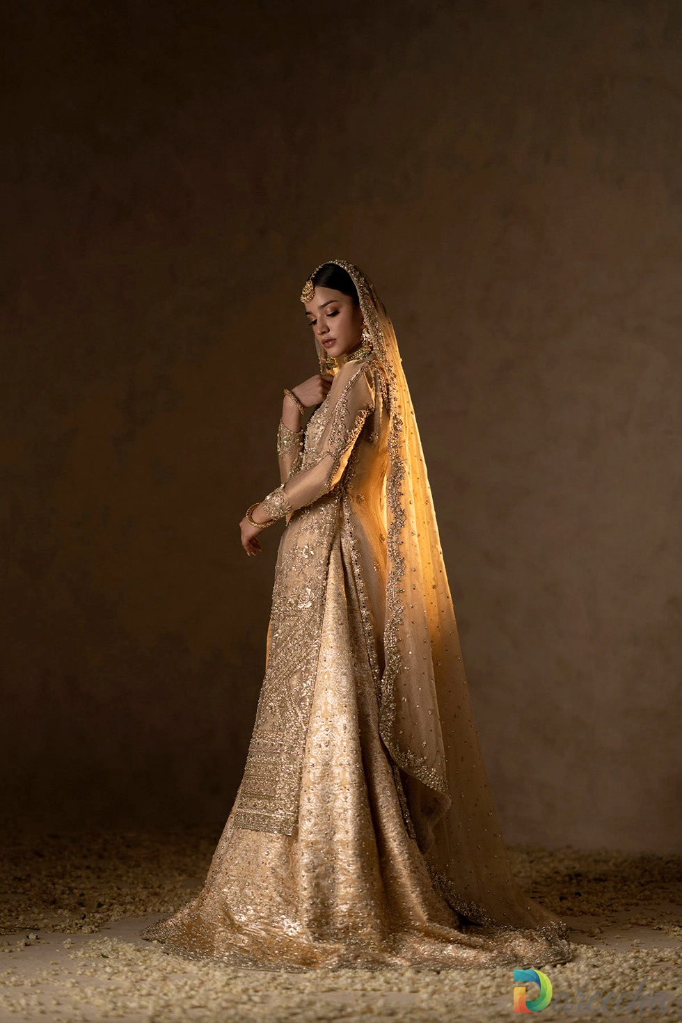 side profile view of gold embroidered gown