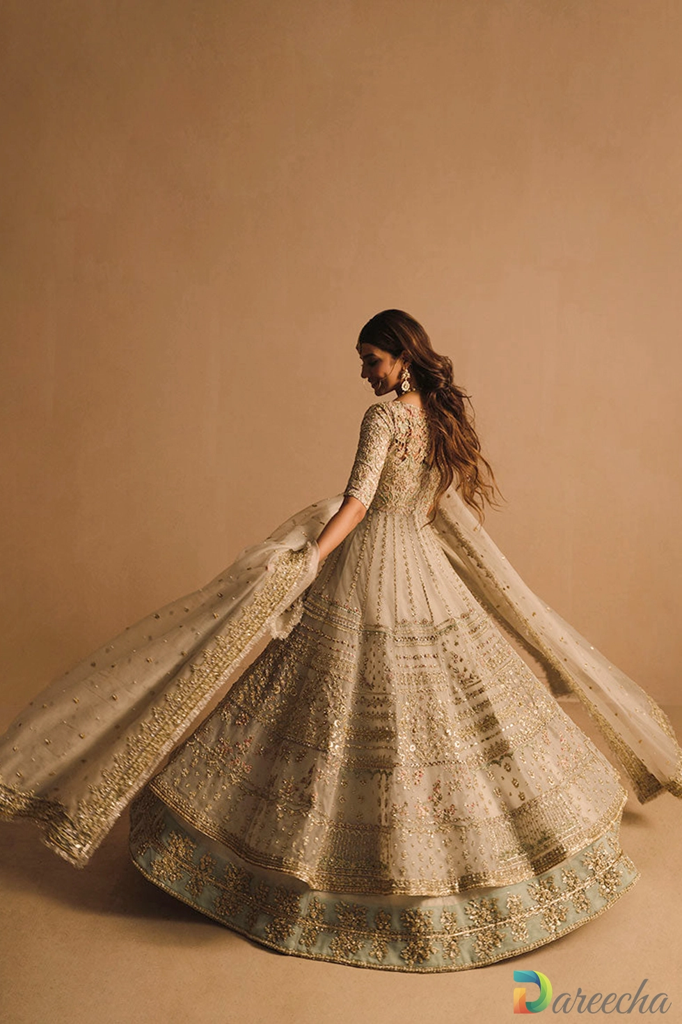 Full length twirling view of white flared net pishwas with lehenga border