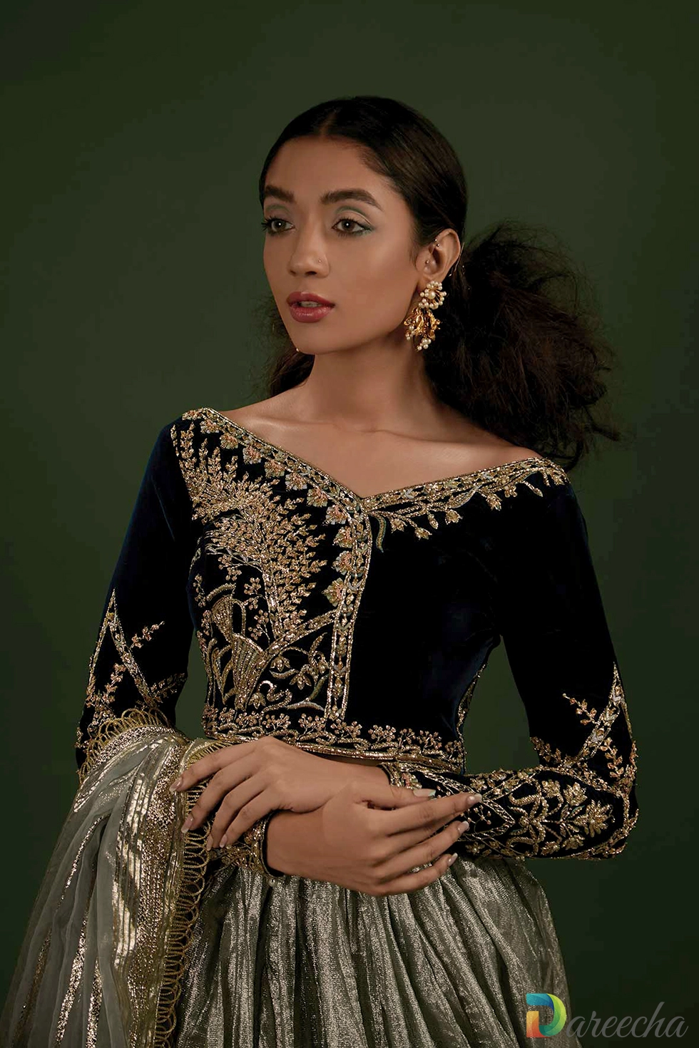 Close up of gold zari embroidered velvet choli top Close up of gold zari embroidered velvet choli top