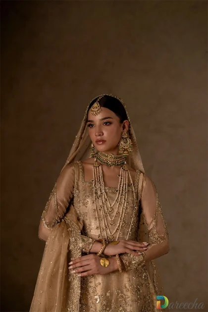 close up of detailed gold neckline and jewels