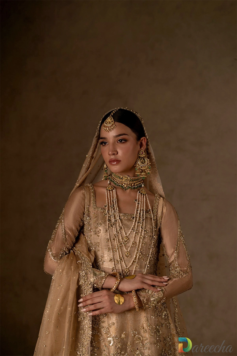 close up of detailed gold neckline and jewels