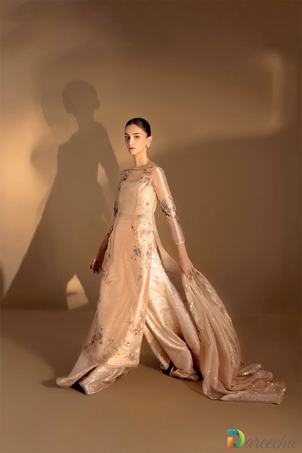 Side pose revealing flared sharara drape and lace borders Side pose revealing flared sharara drape and lace borders
