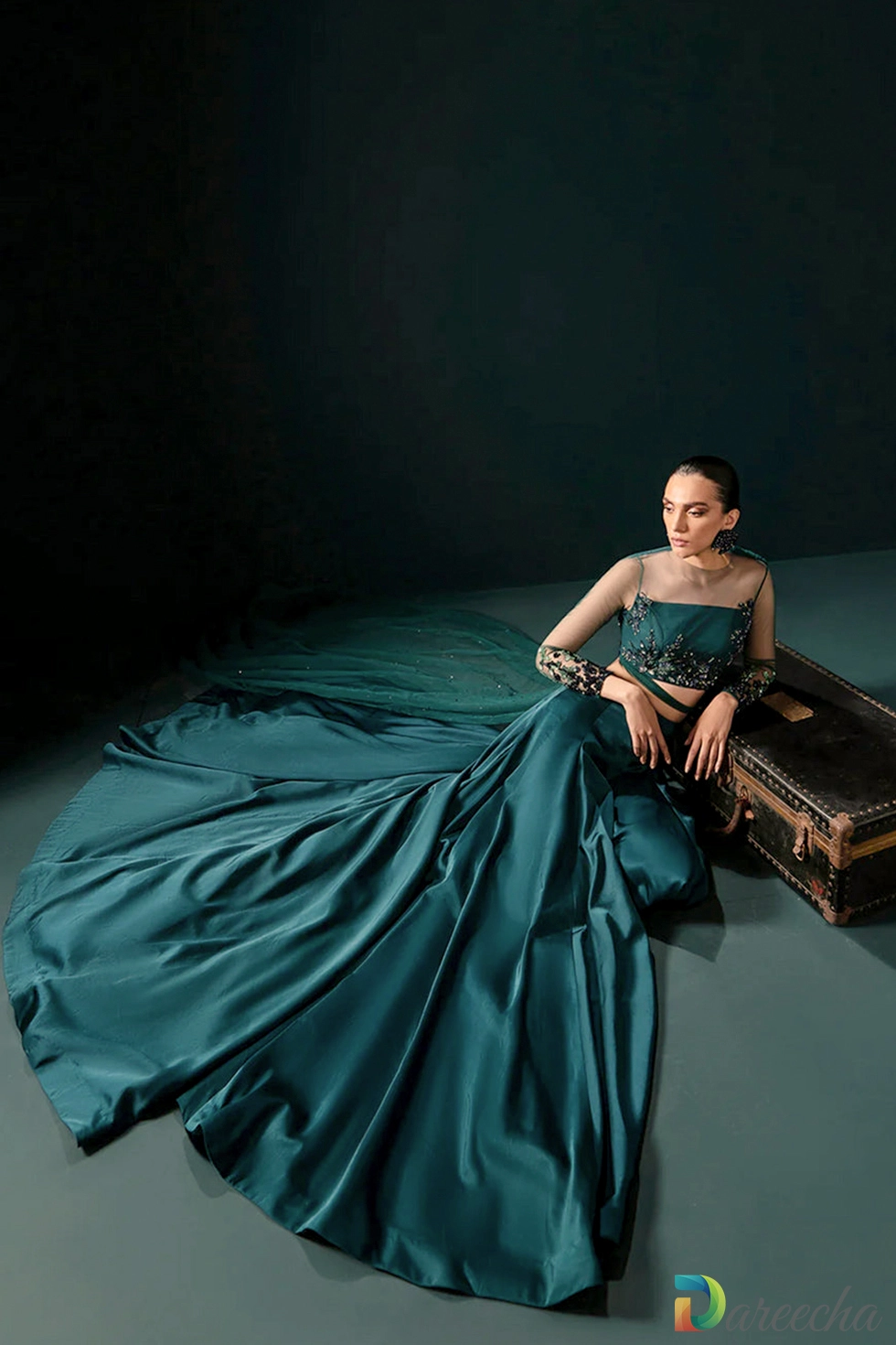Seated view showcasing flared silk skirt and trail