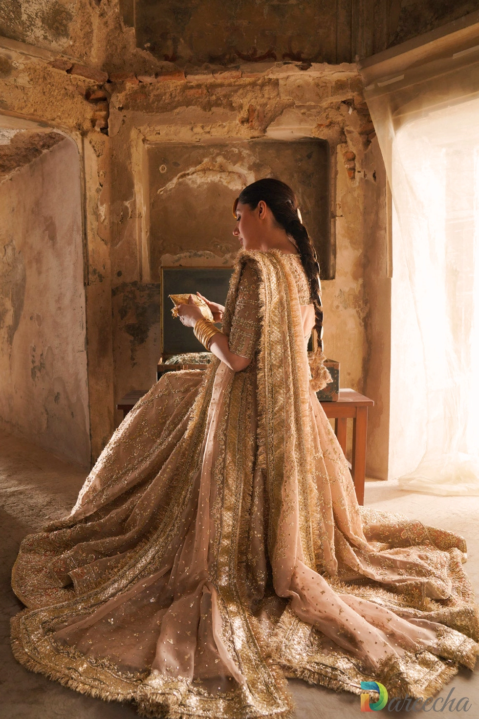 Seated bridal pose highlighting masuri veil and train Seated bridal pose highlighting masuri veil and train